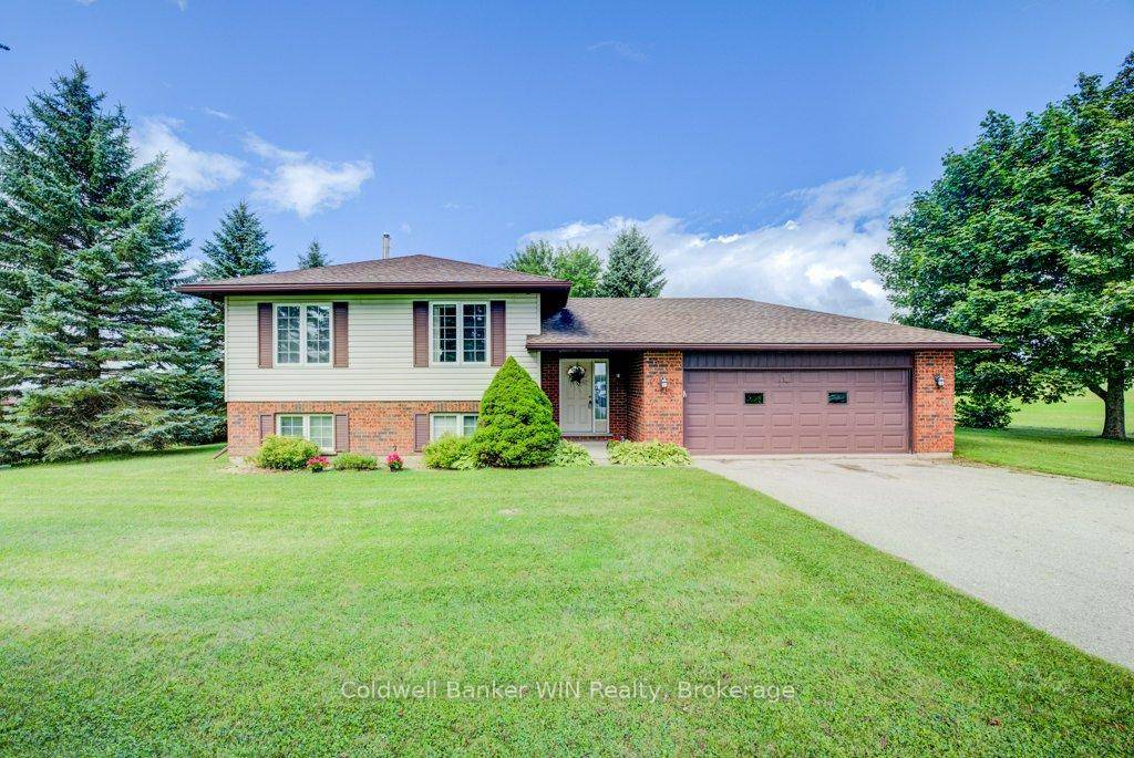 Escape to the peace and privacy of this charming raised bungalow, perfectly situated on a quiet paved road surrounded by mature trees.