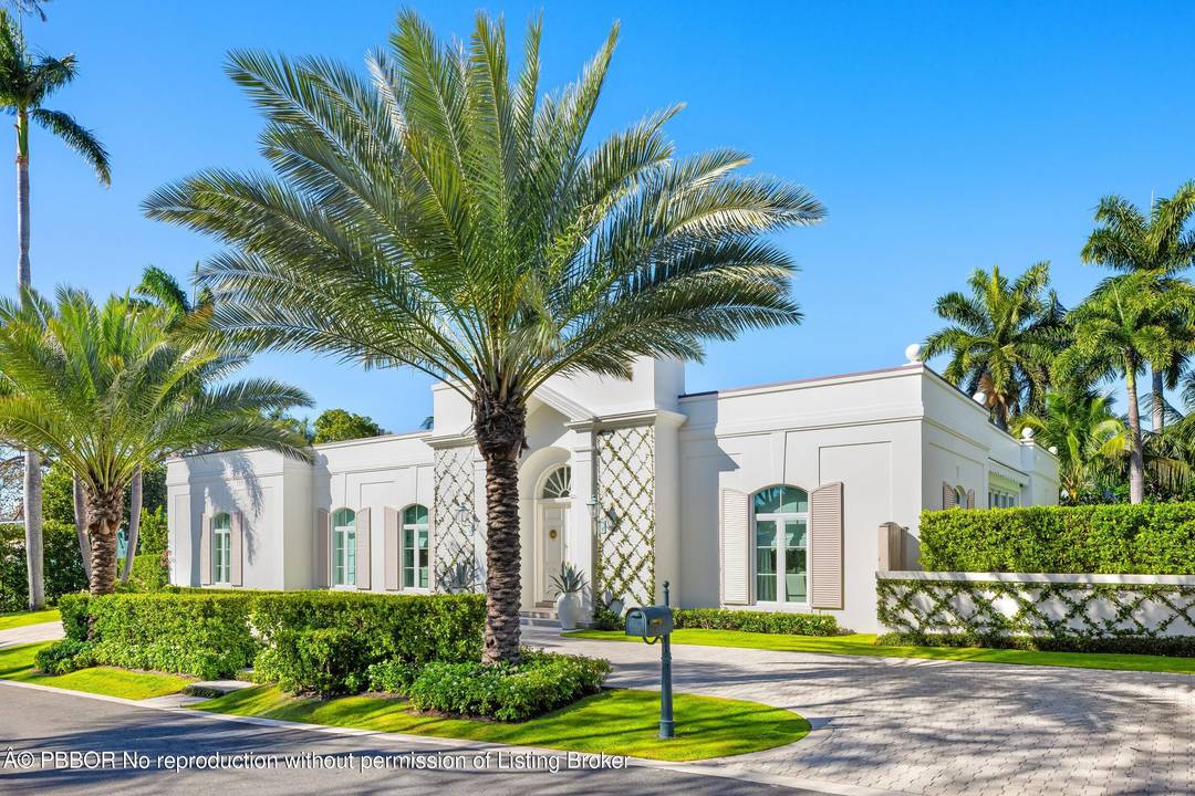 Quintessential Palm Beach Regency surrounding beautiful courtyard.