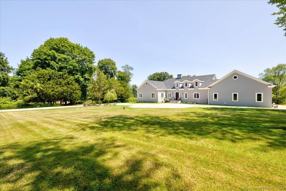 Newer construction featuring elegant French provincial design on over 2 lovely open acres of rolling land bordering an estate area of Greenwich and enjoying a Greenwich address.