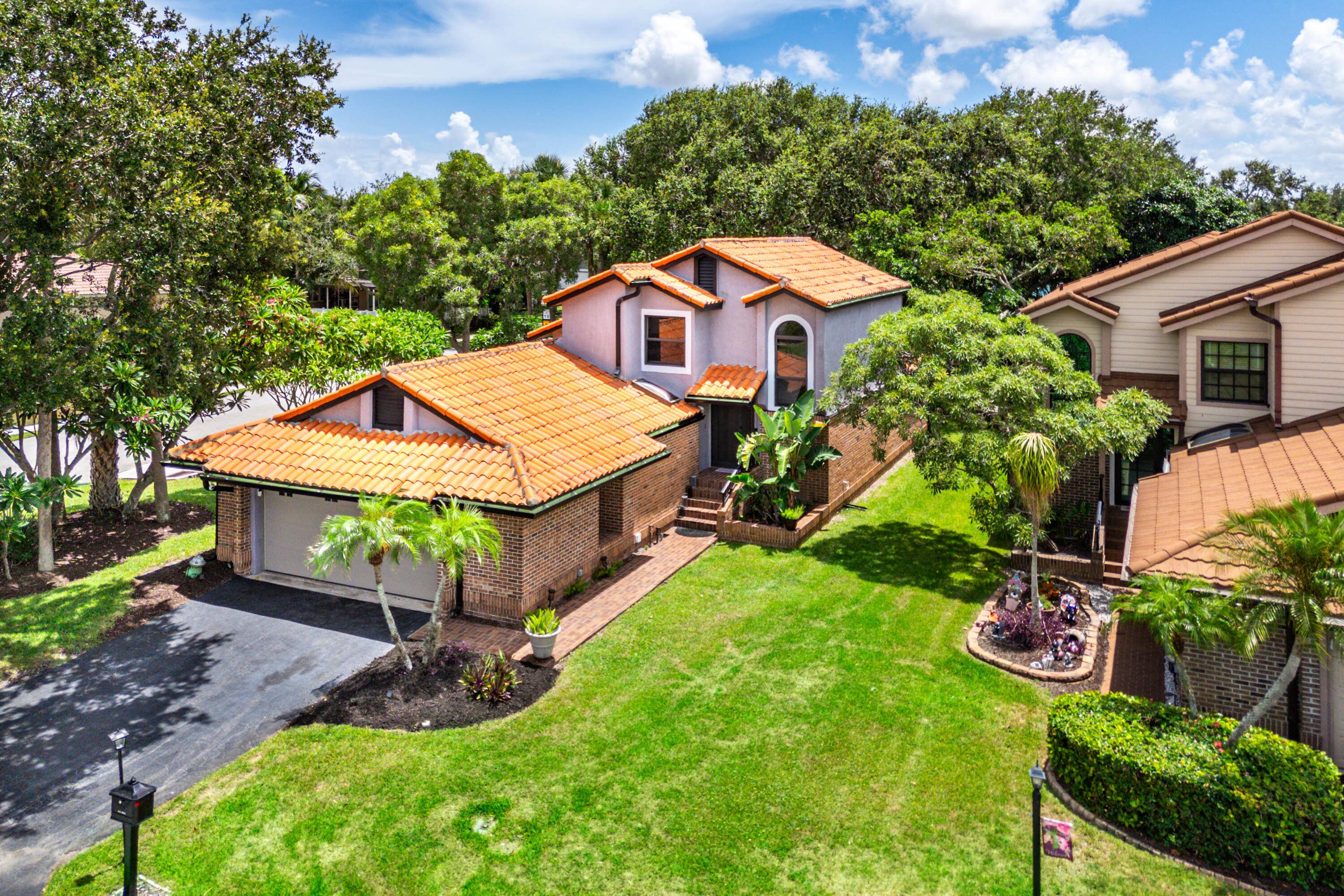 Experience the charm and convenience of Delray Beach living in this former model home, perfectly situated on the largest lot in a serene, tree filled neighborhood.