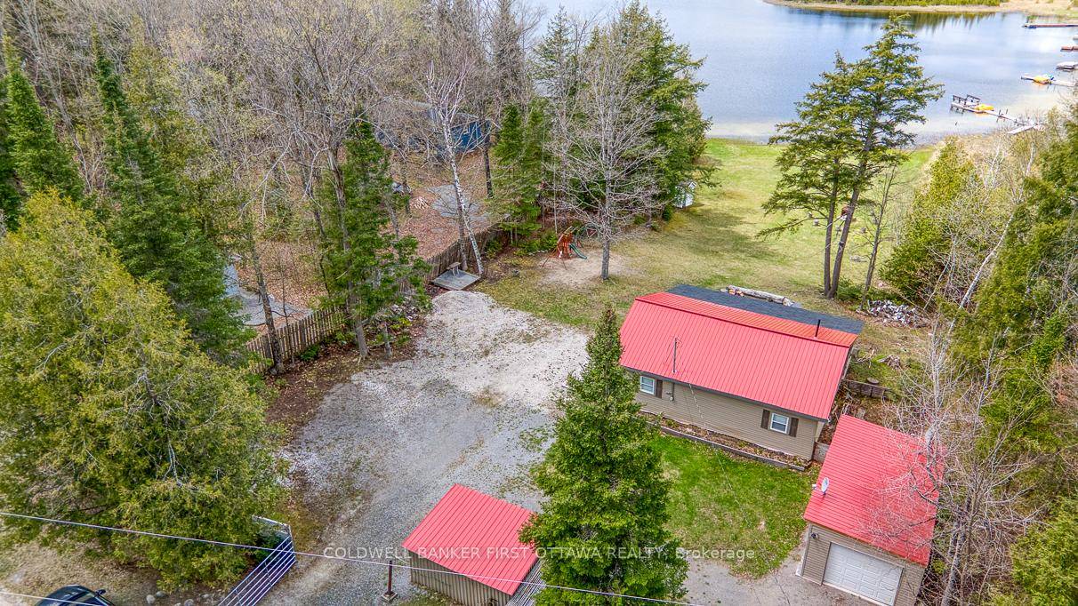 Enjoy the beauty of lakeside living year round at this well kept two bedroom bungalow on quiet and scenic Robbs Lake.