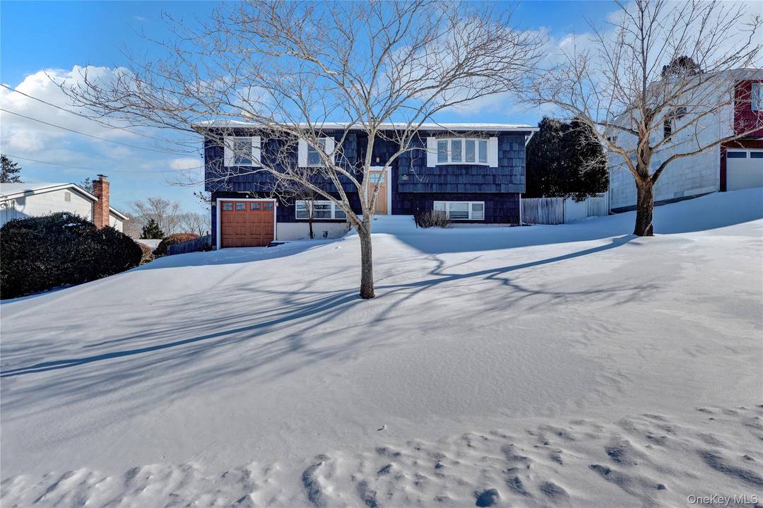 Excellent raised ranch style home with a spacious layout, open kitchen, and rear sliding doors to the second floor deck.