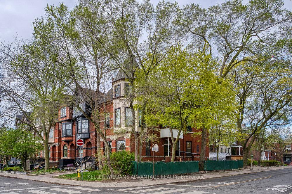 Majestic three storey multiplex available for sale on a large corner lot on a quiet, tree lined street in trendy, bustling Little Italy.