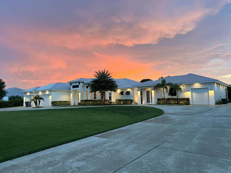 Welcome to a truly exceptional estate home in Palm Beach Country Estates, offering luxury, privacy, and unmatched versatility on nearly 1.
