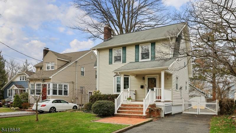 Charming 3 bedroom, 2 bath Colonial featuring a welcoming front porch and classic layout.