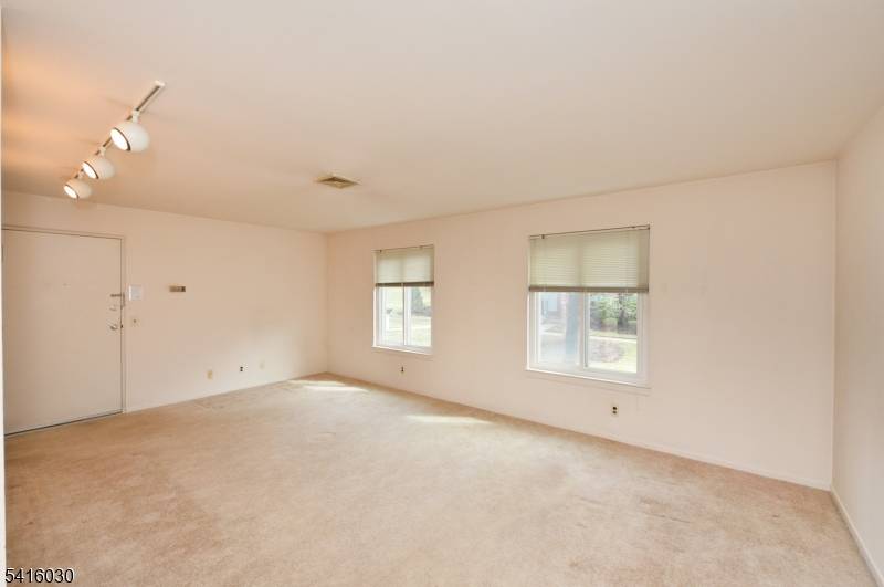 Charming, well maintained second floor one bedroom condo offering a bright, spacious living room and separate dining area, functional kitchen, and a generously sized bedroom with a large closet.