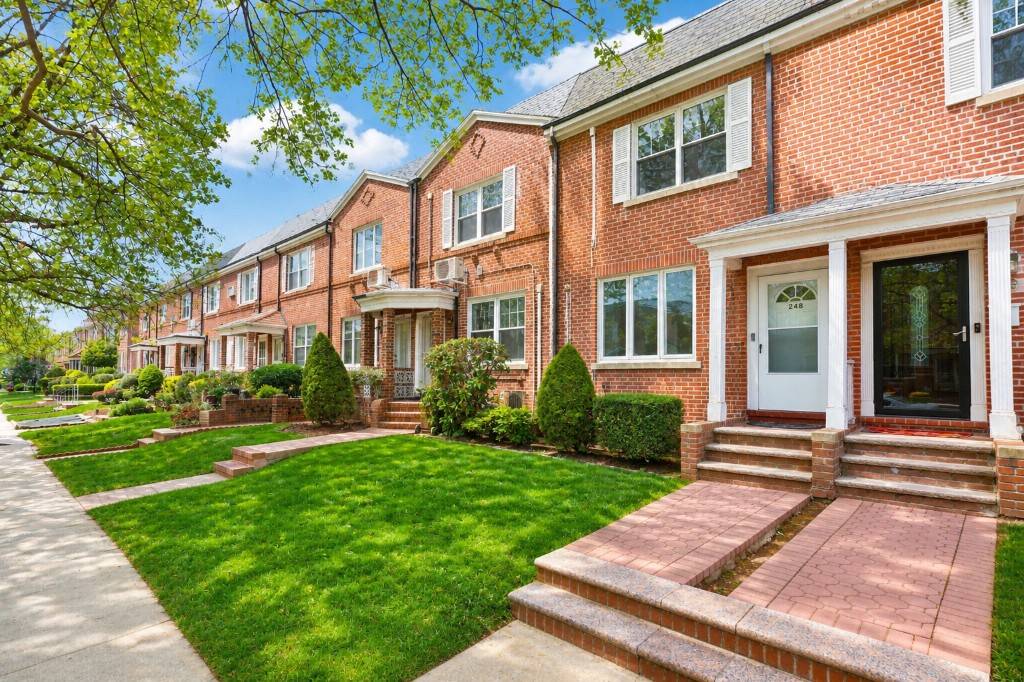 Single family brick home in Bath Beach featuring two stories, a full finished basement, and a detached garage accessed via the community driveway.