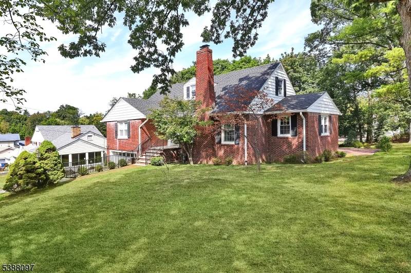 Set on a picturesque, tree lined street in Great Notch, this brick home offers multiple levels for a versatile layout and flexible living arrangements.