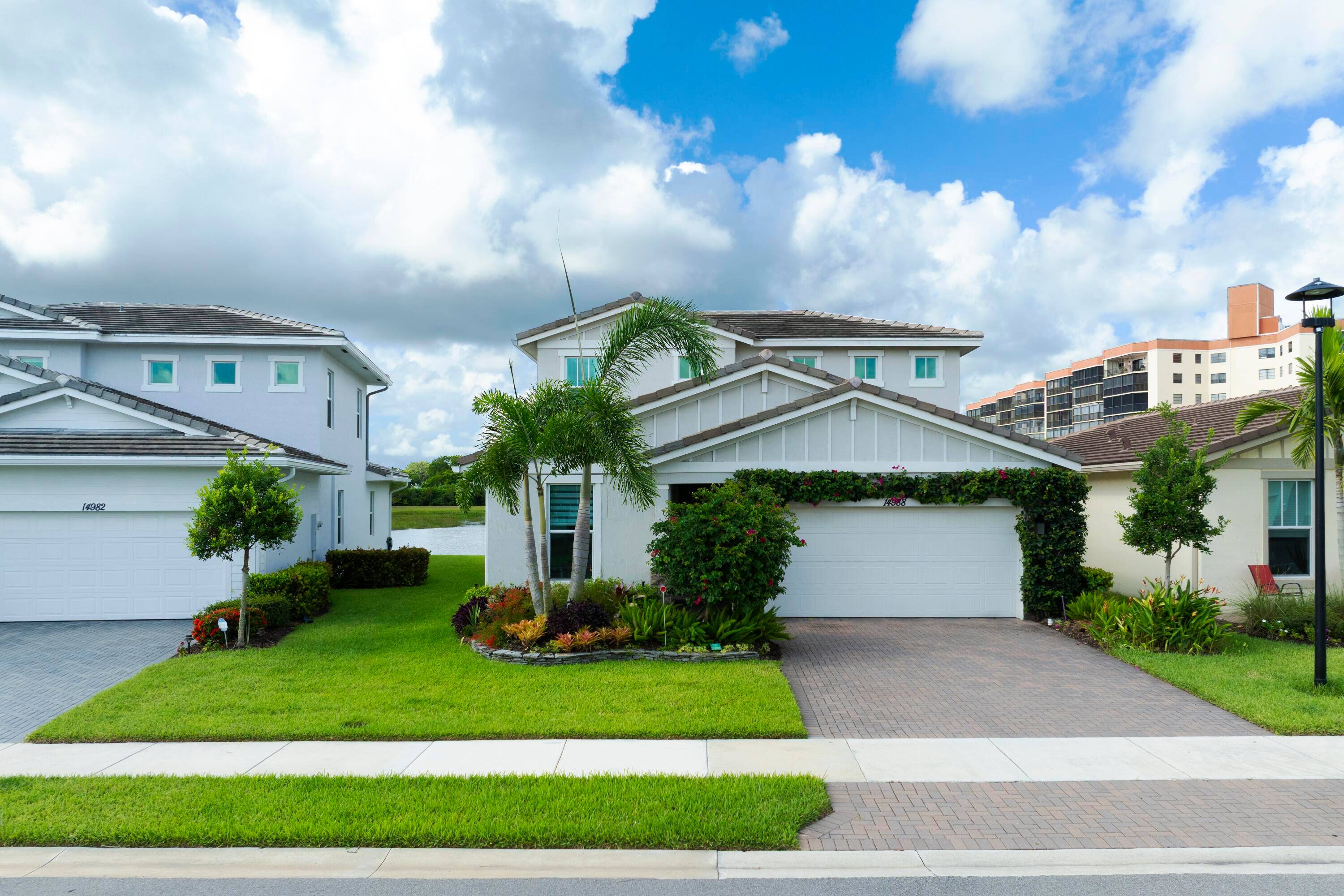 Stunning, move in ready home with long lake views in the 55 community of Avalon Trails in Delray Beach.