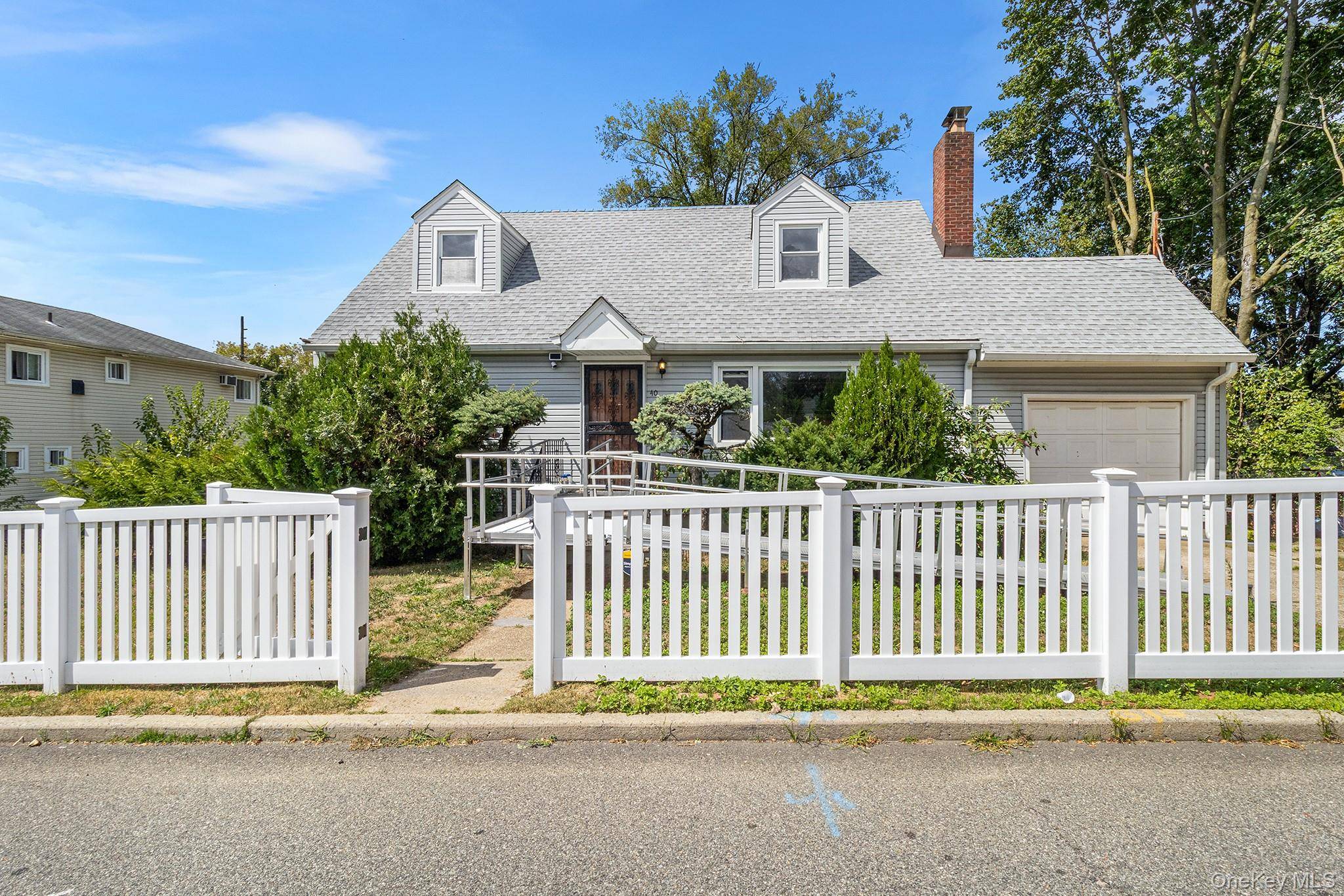 Two family home in the heart of Elmont on an oversized park like property.