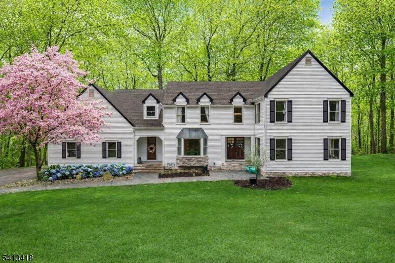 Welcome to this beautifully reimagined 4, 437 square foot Colonial, privately nestled on 4.