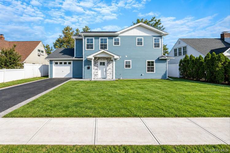 Striking from the moment you arrive, this newly renovated and expanded two story home pairs crisp exterior lines with a stone accented entry, and driveway leading to the attached garage.