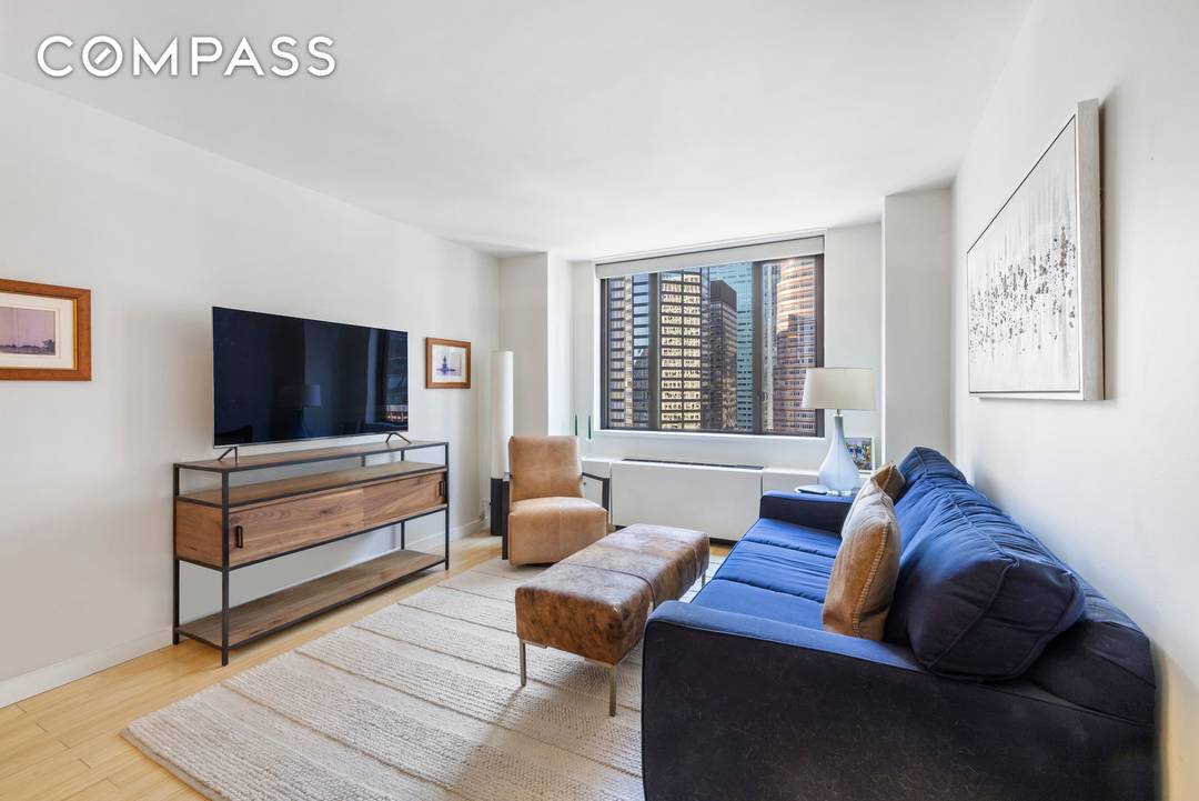 Located high above coveted Sutton Place, this meticulously updated one bedroom residence captures sweeping south facing city views, showcasing a dramatic New York skyline highlighted by the new JP Morgan ...