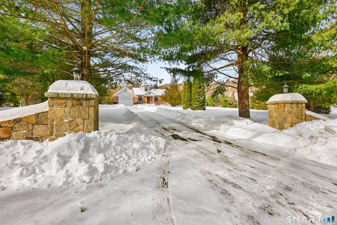 Stately and impressive home featuring a dramatic stone pillar entrance, ideally located directly across from Lake Zoar with deeded private dock access.