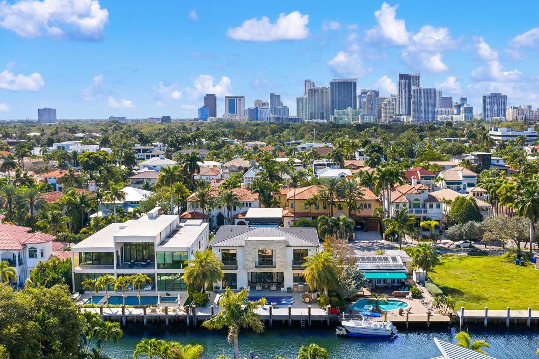 Located in Las Olas Isles, this modern residence by CES Design Group features a 7' elevation and a dramatic 32' double height entryway that opens to interiors finished with porcelain ...