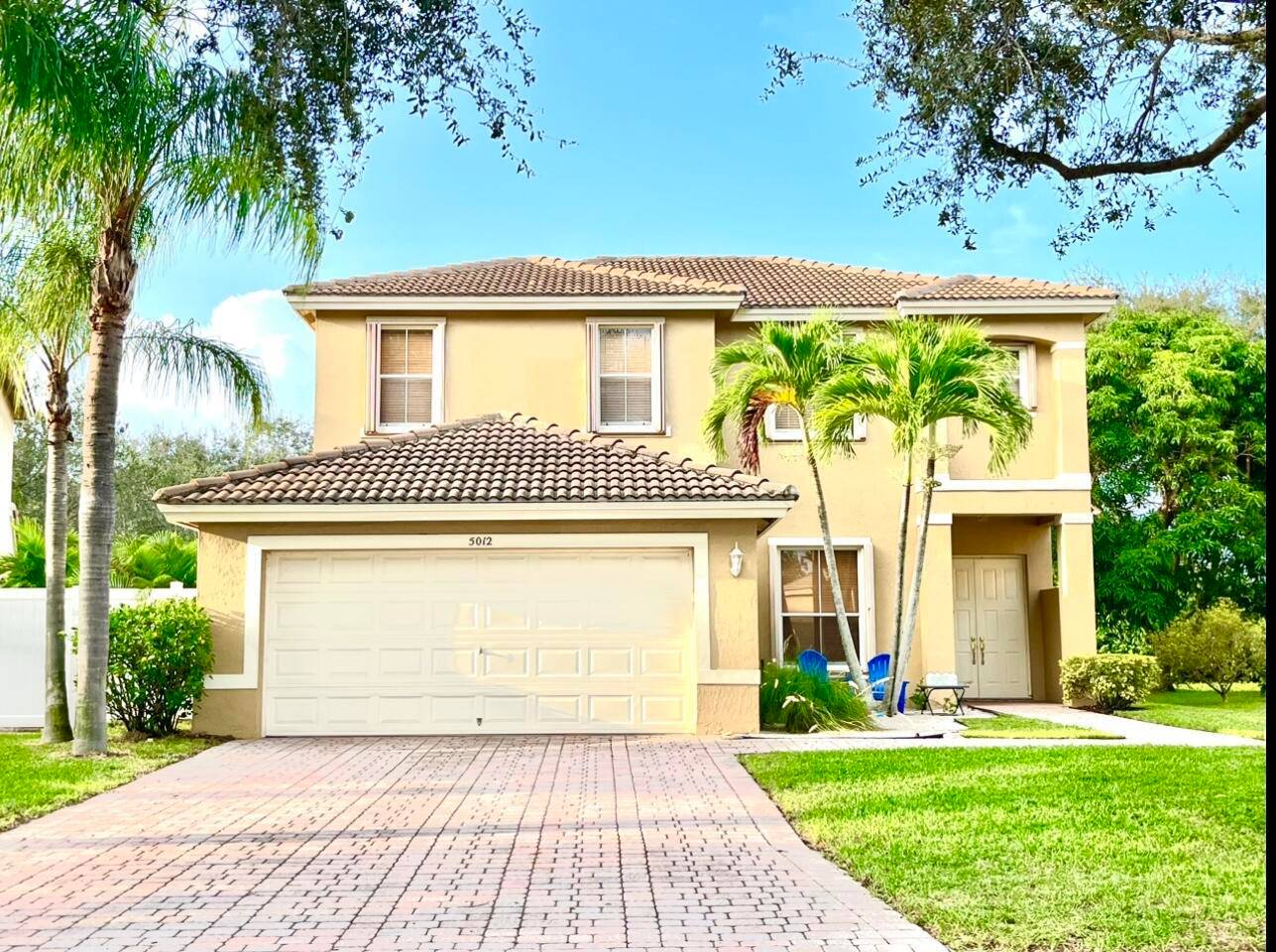 Discover your piece of paradise at 5012 Victoria Circle, located in the premier gated community of Lakes of Laguna in West Palm Beach.