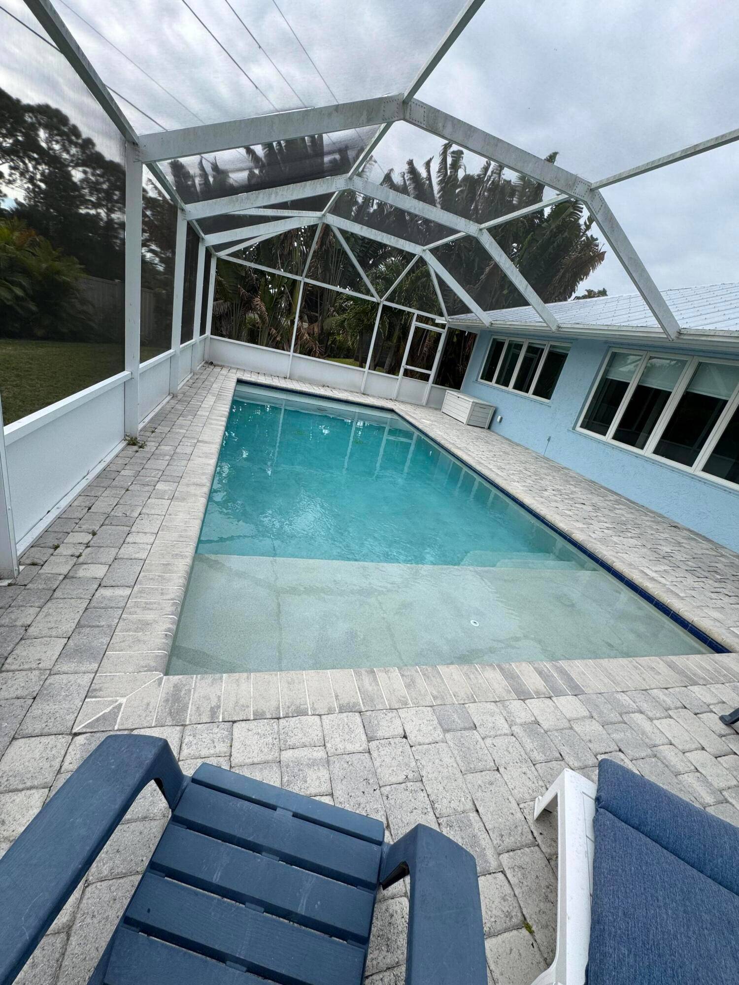 Bathed in natural light this completely remodeled home with volume ceilings has a new metal roof 2023 24, A C 2019, PRIVATE pool with sunning shelf 2018, large format porcelain ...
