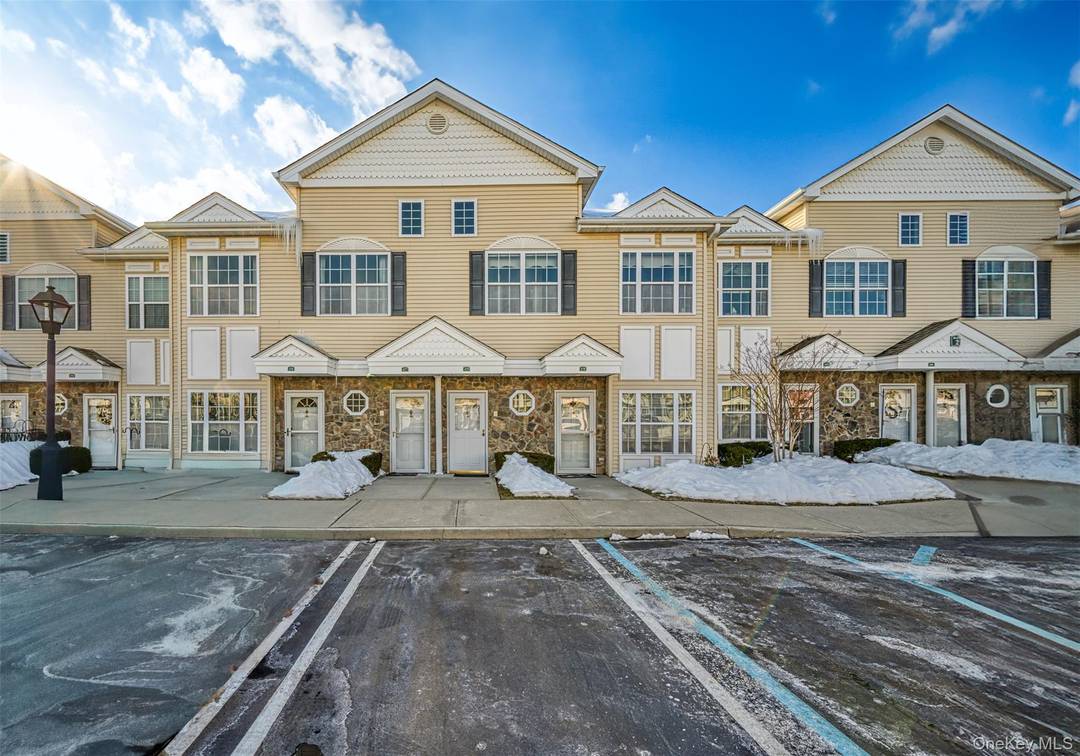 Welcome to 479 Spring Drive, where timeless style meets effortless living in the highly desirable gated community of The Seasons at East Meadow.