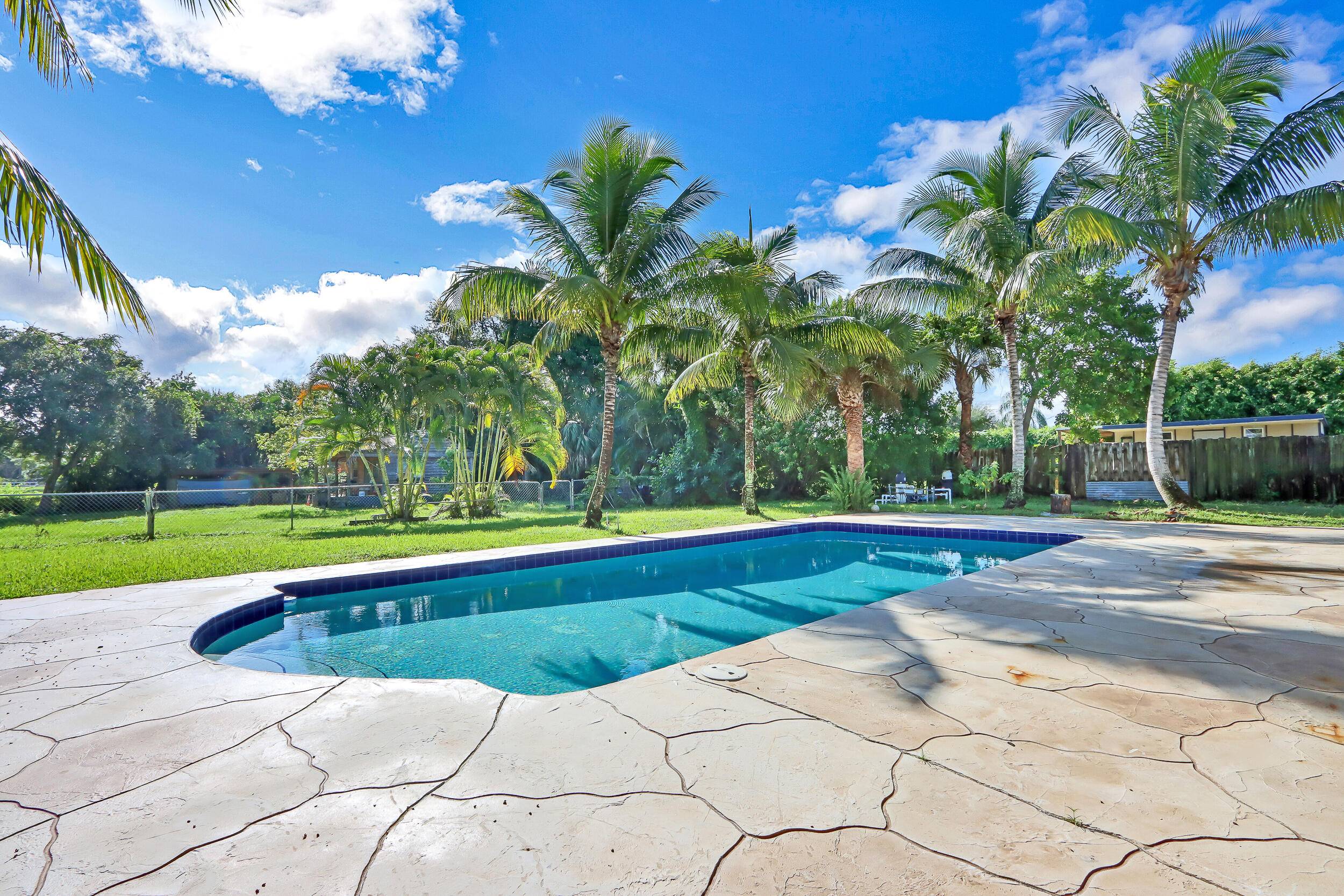 This spacious home combines privacy, comfort, and outdoor living on nearly an acre east of I 95.