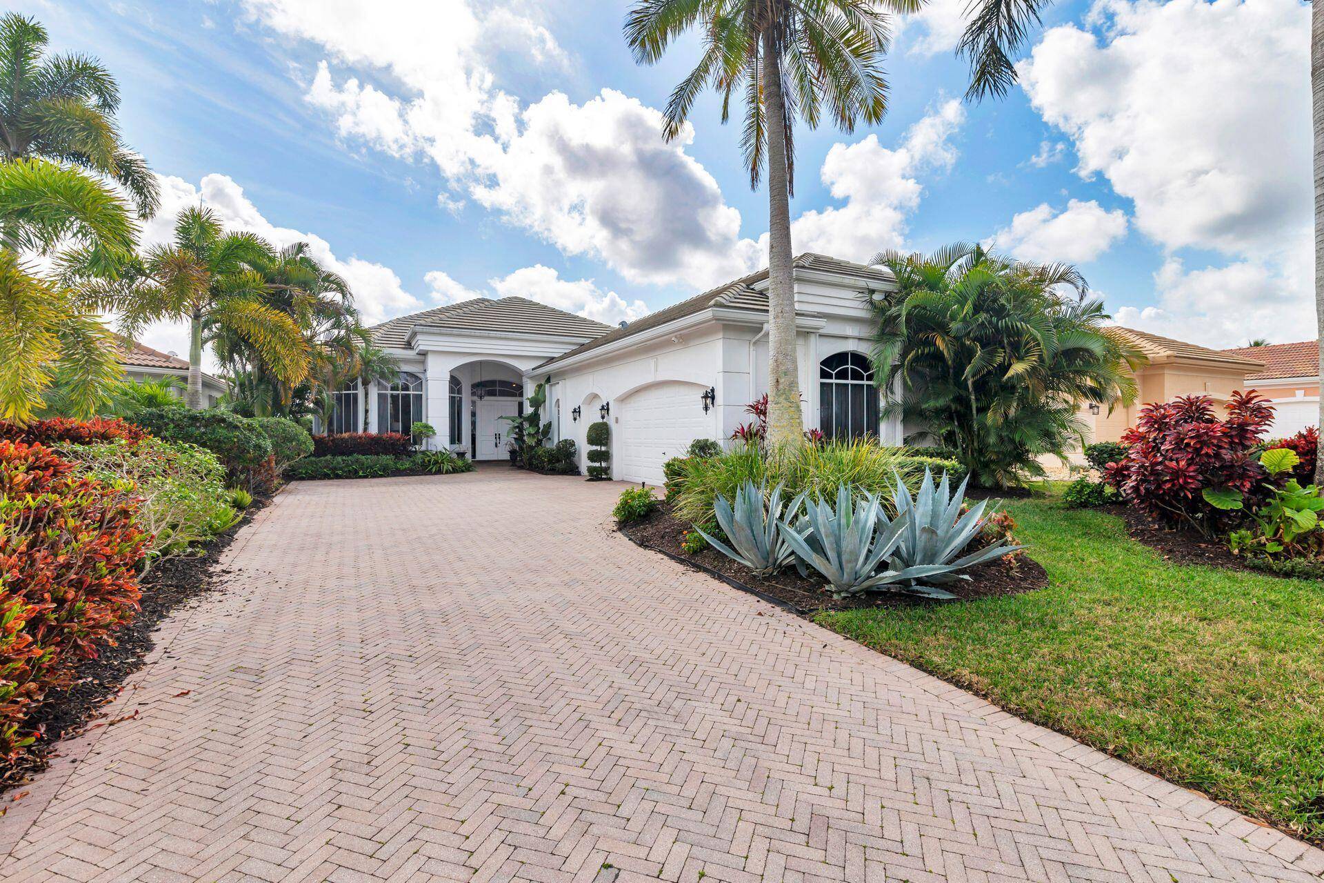 Mediterranean style home features 3BR 4FB, along with screened in lanai pool and picturesque golf courseviews.