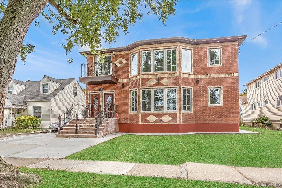 New two Family Solid brick Mid block driveway, garage.