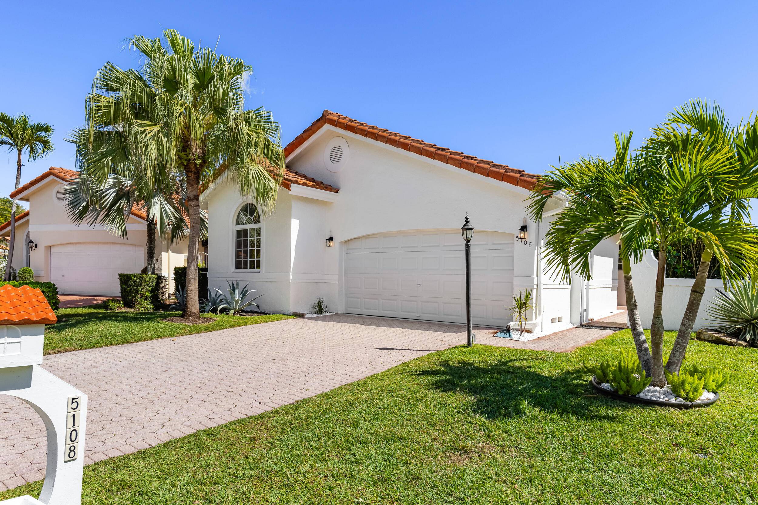 Welcome to this stunning, fully renovated LAKE view home on a quiet cul de sac in the Delray Beach's highly desirable GATED community of Bel Aire.