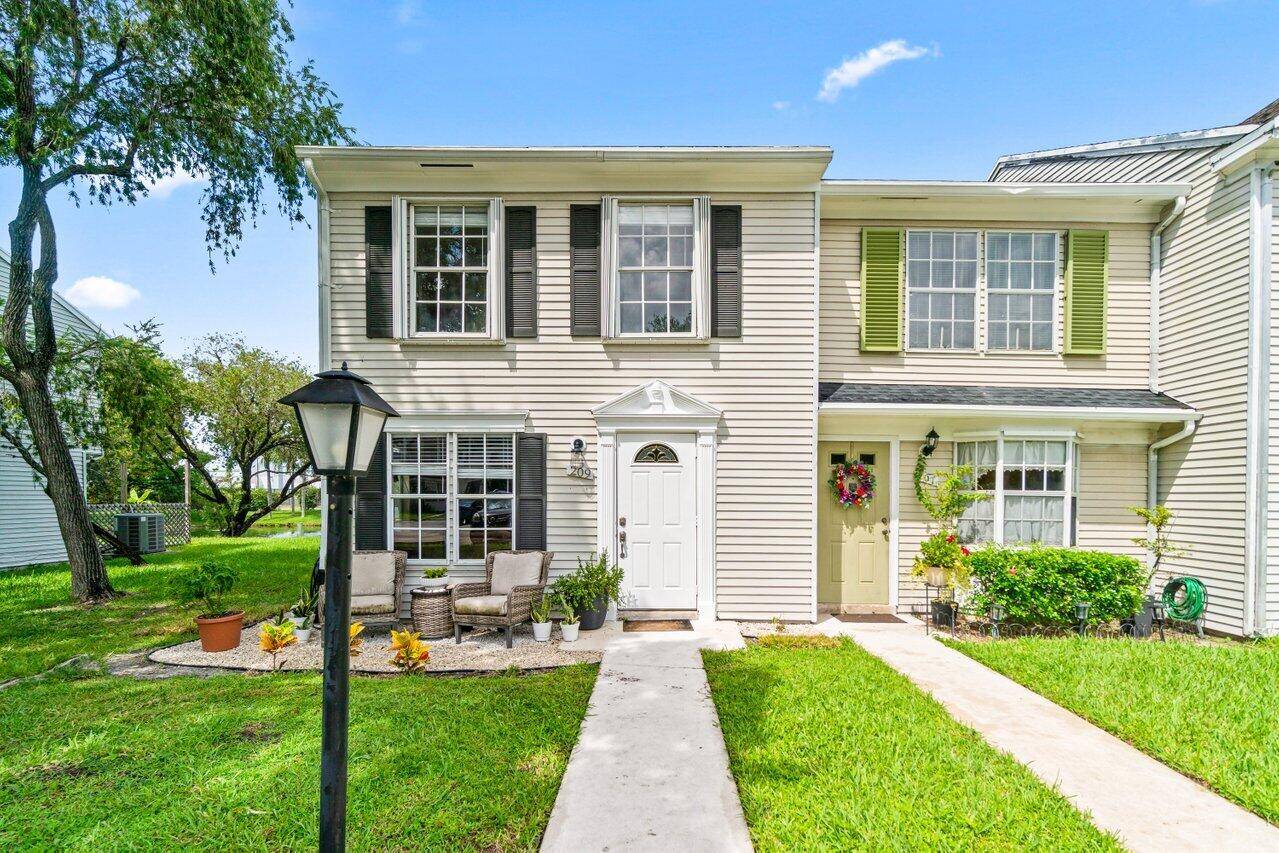 This charming end unit, lakefront townhouse in the highly desirable Georgian Park community offers peaceful water views and extra privacy with lush green space surrounding the home.