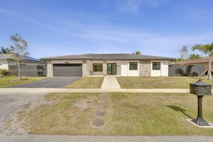 Enjoy Incredible Sunsets at this Gorgeous Lake Front Home located in the desired City of Weston !
