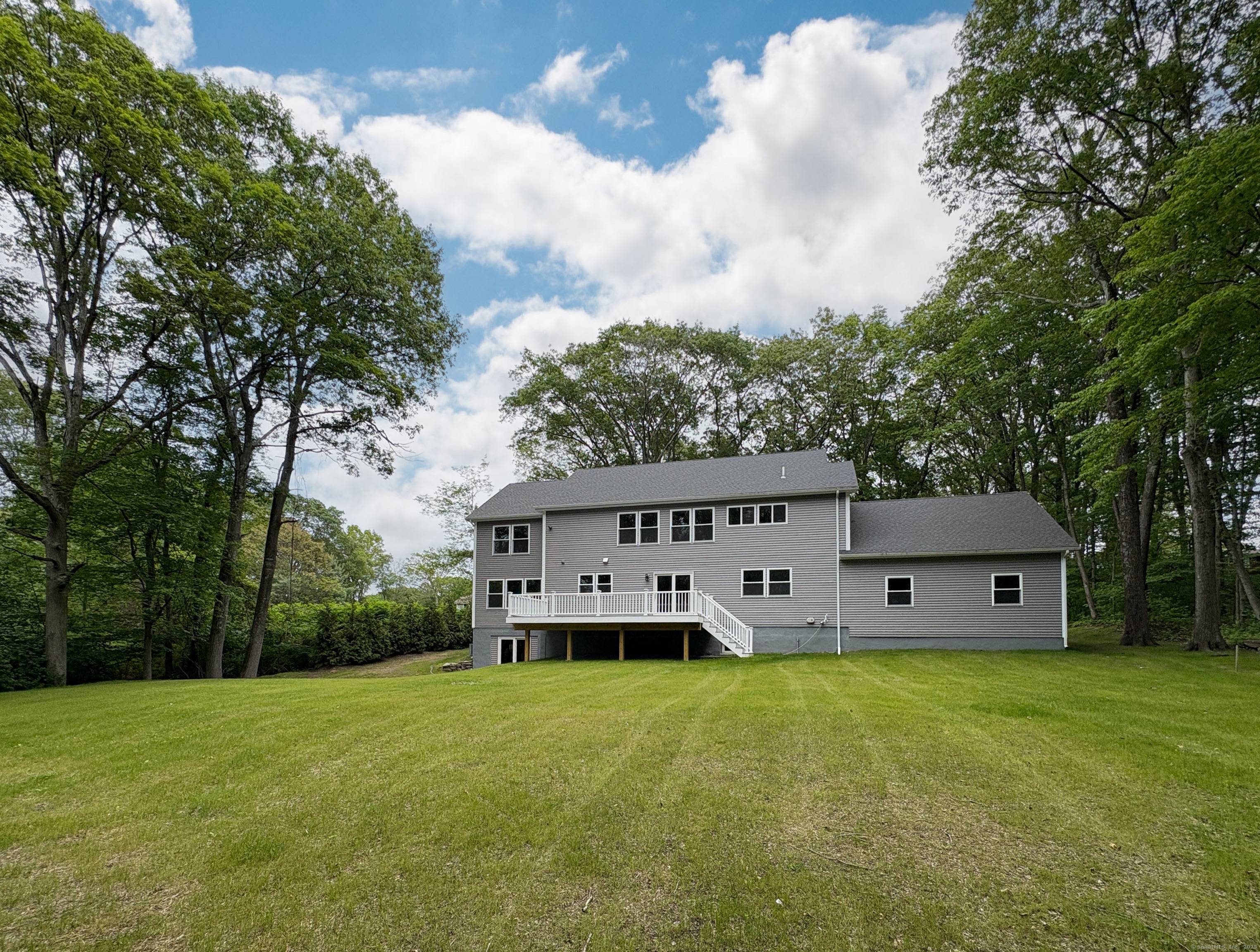 This beautifully built 5 bedroom, 4 bath colonial blends classic elegance with modern luxury in a serene interior lot setting.
