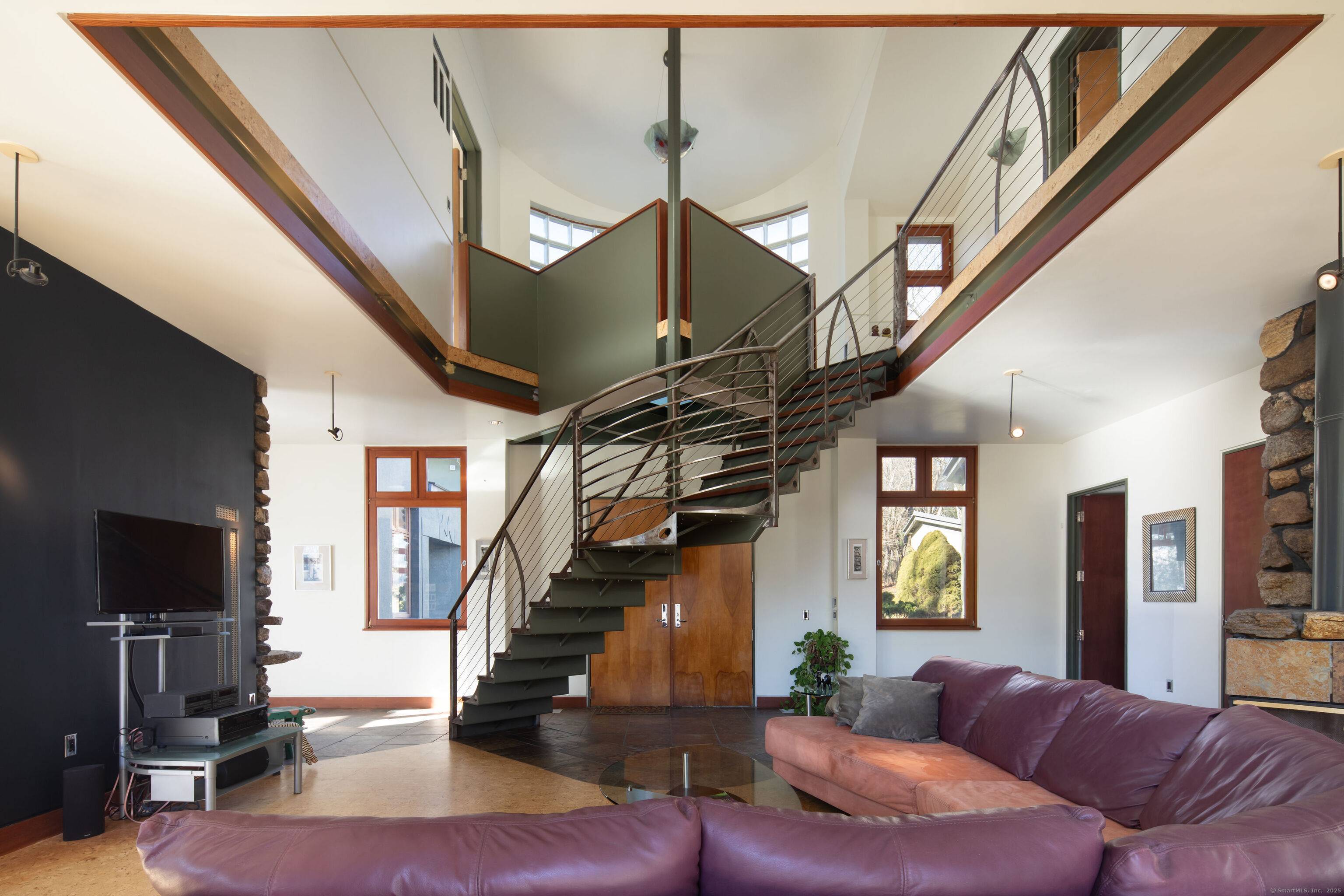 Thoughtfully designed for the 21st century, and mindful of quality and sustainability in every detail, this unique home sits high above Ridge Road with privacy and timeless views.