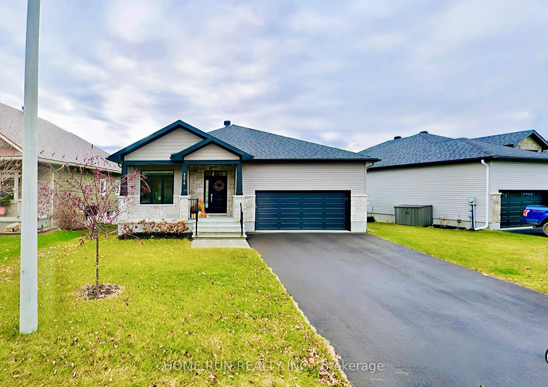 Stunning custom built bungalow with walkout basement, perfectly positioned on a premium hilltop lot in Carps newest neighborhood.
