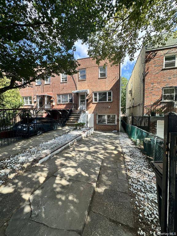 Semi attached brick home in the Bronx featuring 3 bedrooms, 2 baths, and a finished basement.
