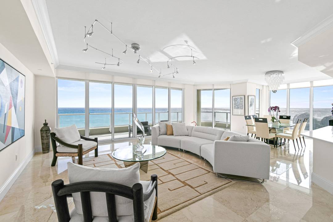 Experience ultimate coastal living and panoramic views in this stunning fifth floor residence at Ocean's Edge, an exclusive gated community on Singer Island.