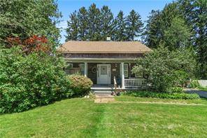 This antique Cape Cod graces a lovely, wooded level lot.