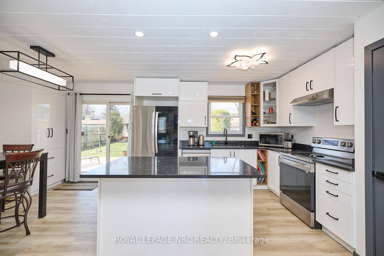 RENOVATED BUNGALOW WITH VAULTED CEILINGS ON A LARGE PIE SHAPED LOT !