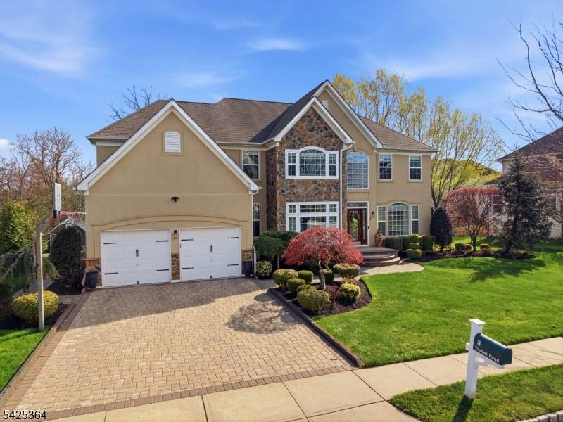 Welcome to this exceptional 5 bedroom, 4 full 2 half bath home, perfectly situated on a premium lot backing to woods.