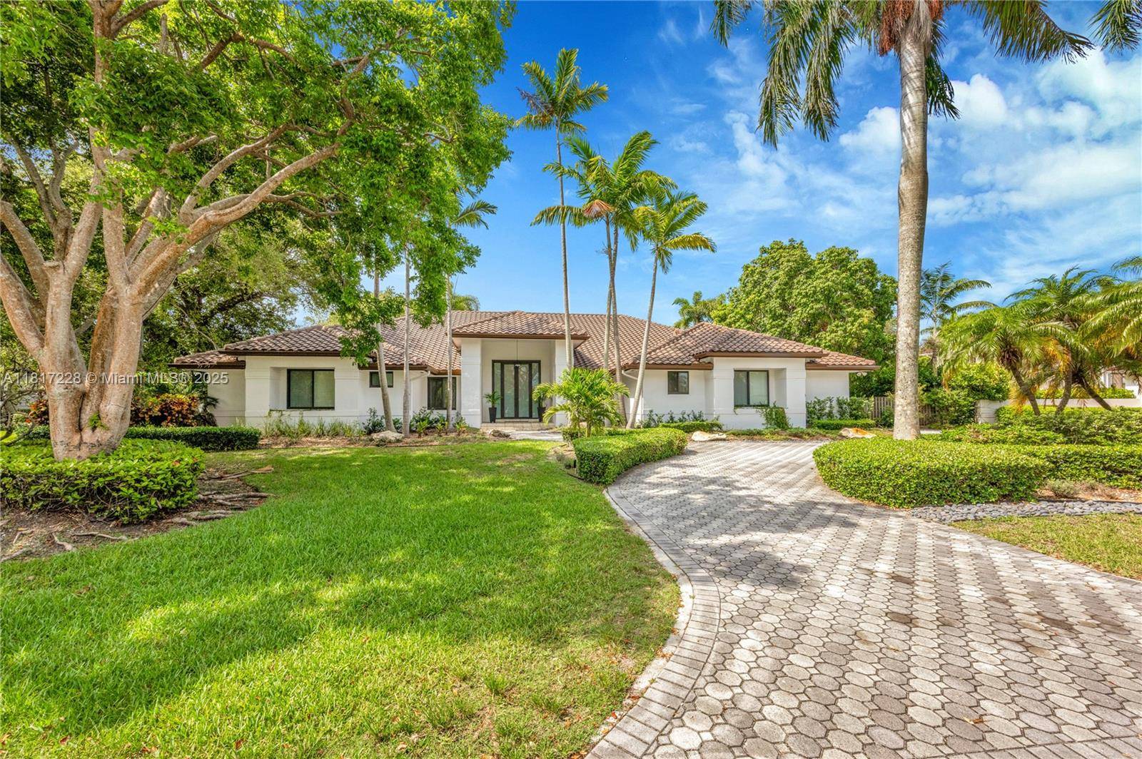 Located in the gated community of Old Cutler Groves South, this meticulously updated 5 bedroom, 4.