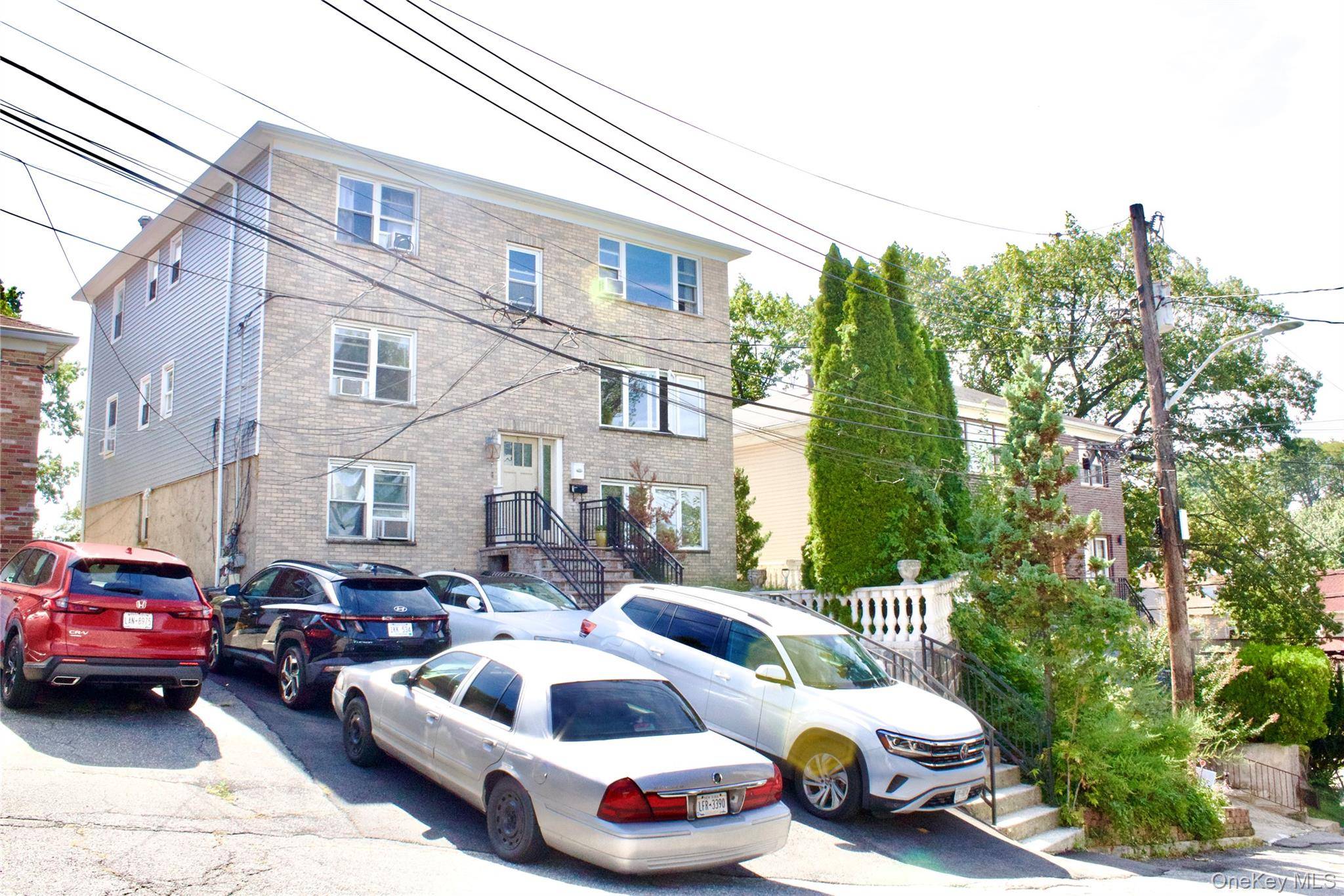 Welcome to 8 Elicar Terrace, a stunning brick Colonial duplex nestled on a quiet, tree lined street in Yonkers' sought after Bryn Mawr neighborhood.