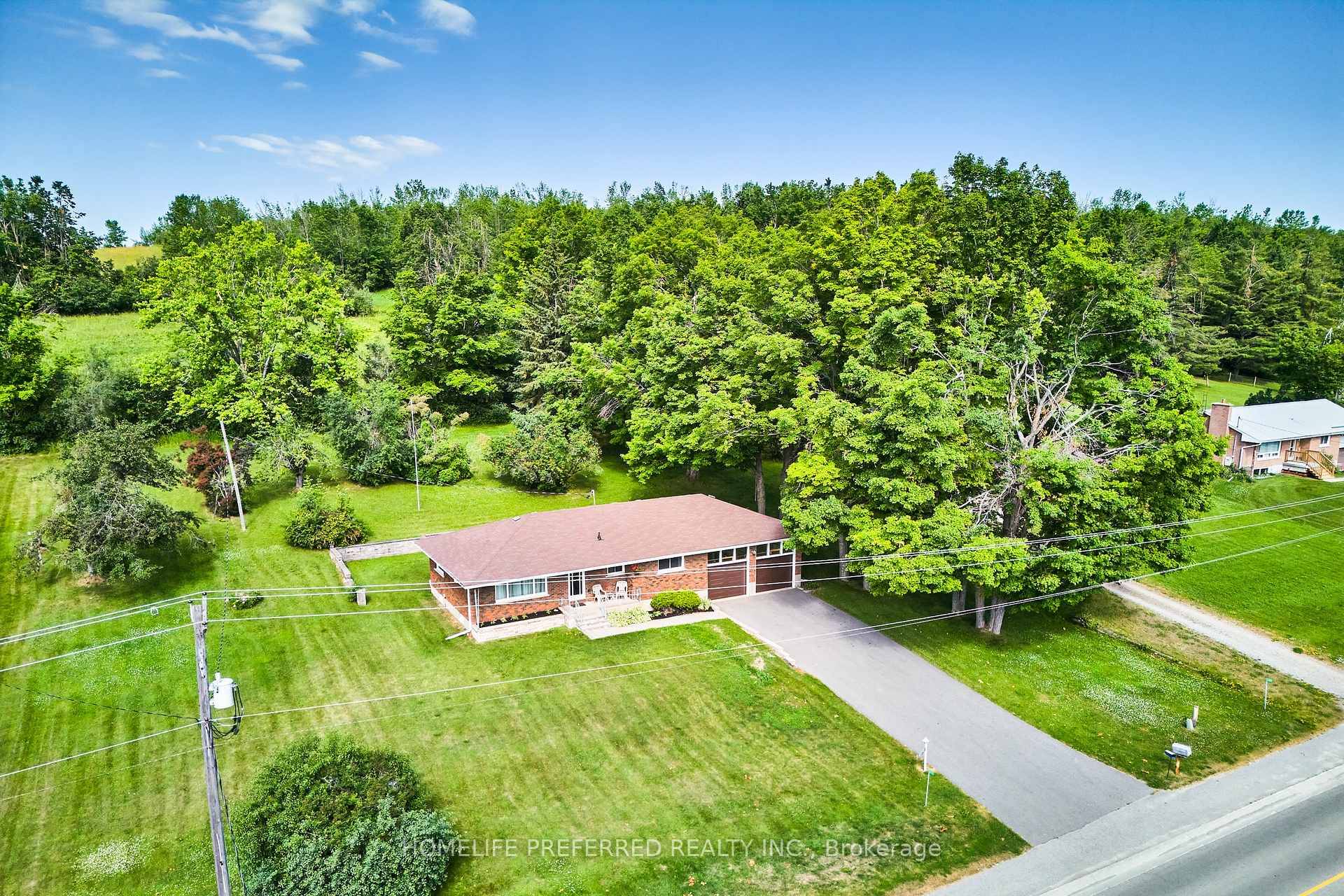Wonderful curb appeal ! Lovely red brick bungalow with 2 car attached garage, all set on a landscaped lot measuring just under an acre and backing onto farmland.