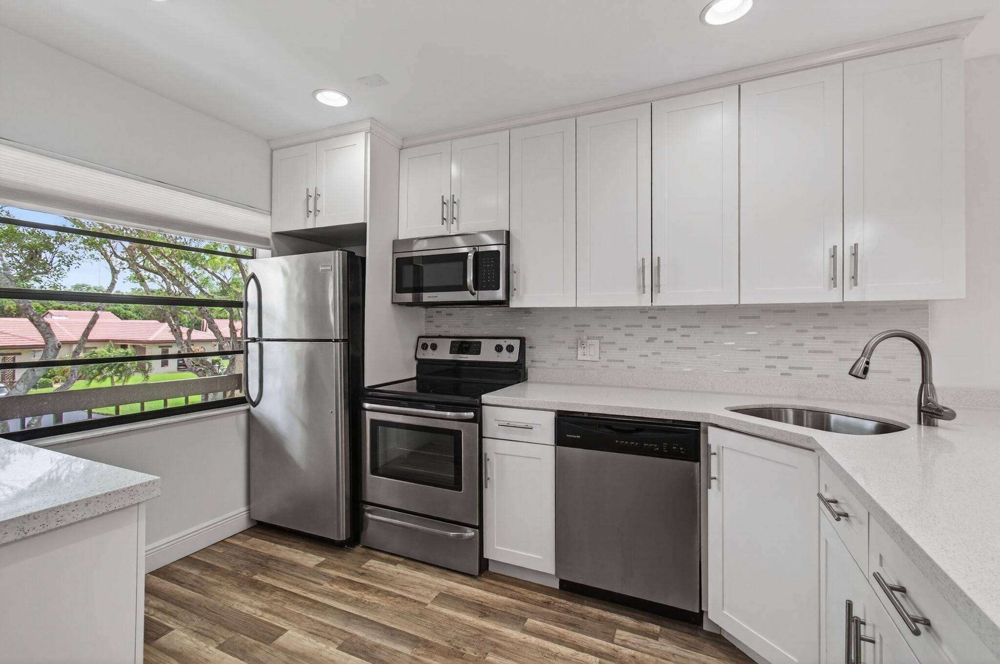 Gorgeously updated 2BR 2BA corner unit with private entrance in the sought after 55 gated community of Fairways of Boca Lago.