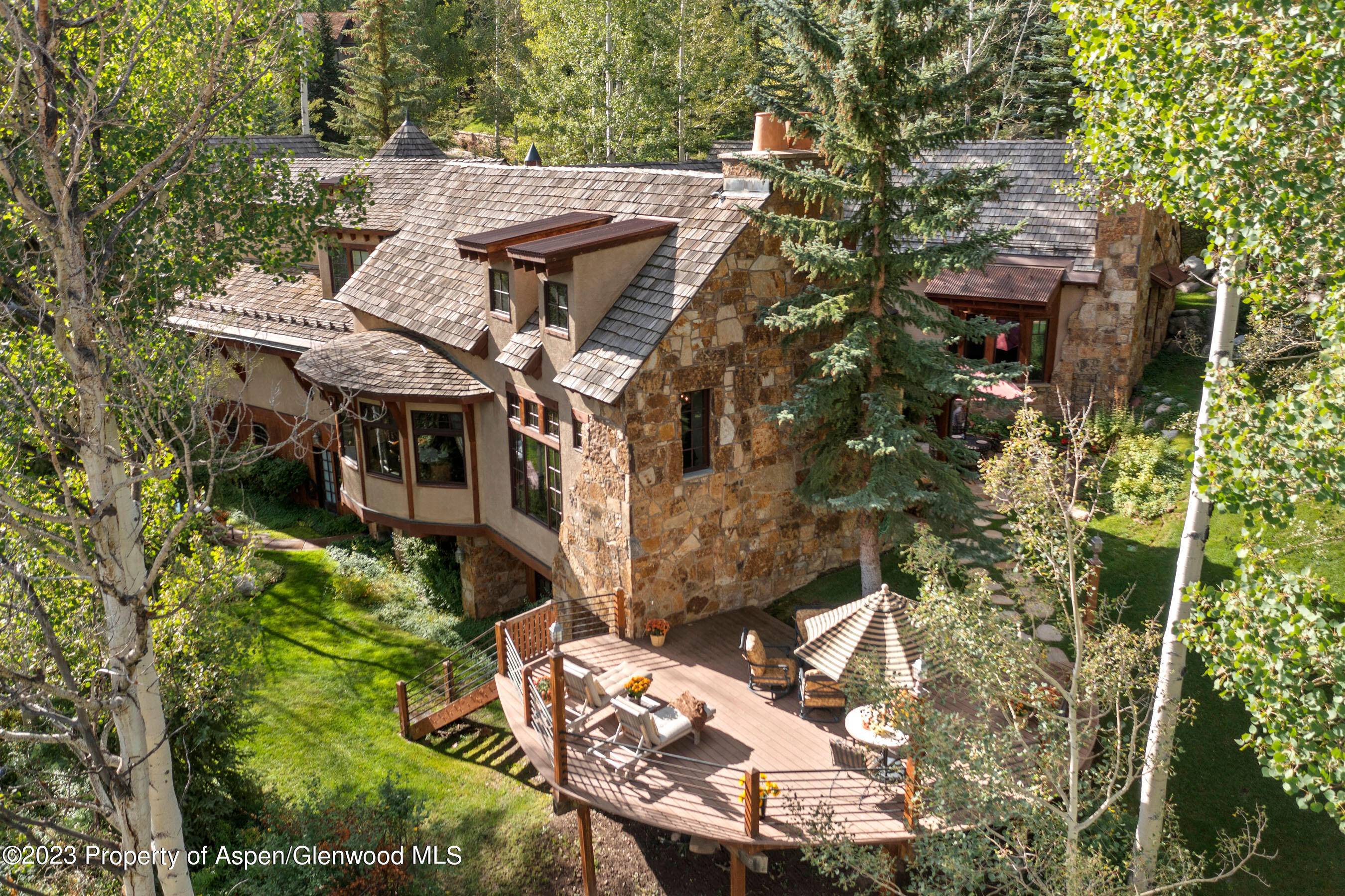 A spectacular mountain lodge on a very private, near 2 acre site in the prestigious Divide neighborhood.