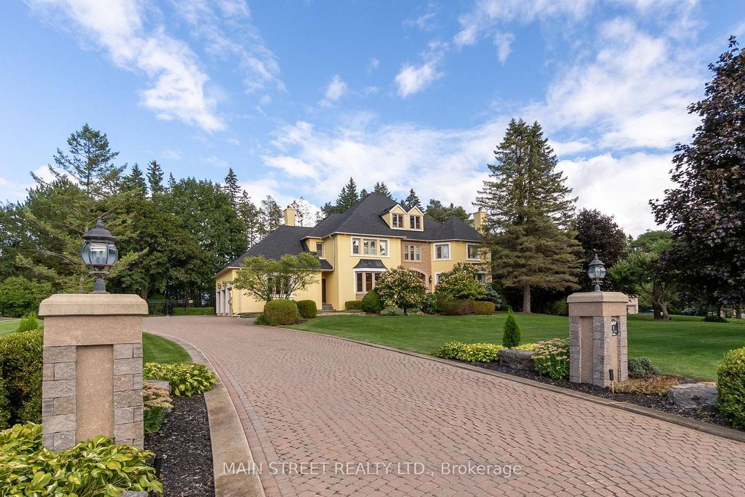 Tucked away on a lush, one acre private lot, this extraordinary custom built residence offers approx.