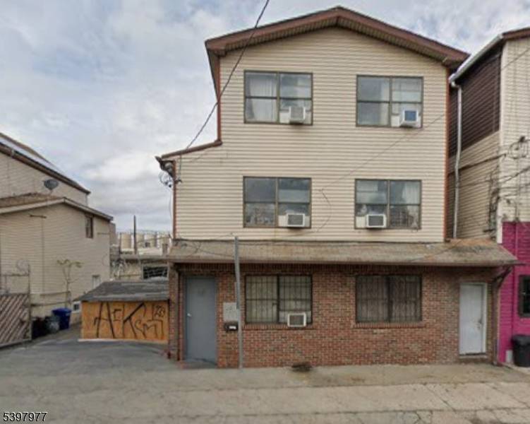 Located in a desirable area of the Ironbound section, on a lot approximately 30x87, featuring two large garages and additional parking for up to eight cars.
