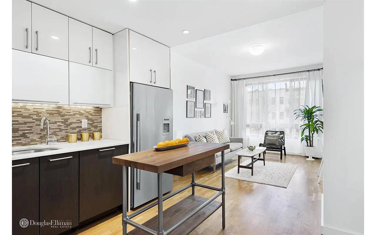 Step into the expansive living room, where natural light floods the space, creating a warm and inviting atmosphere perfect for both relaxation and entertaining.