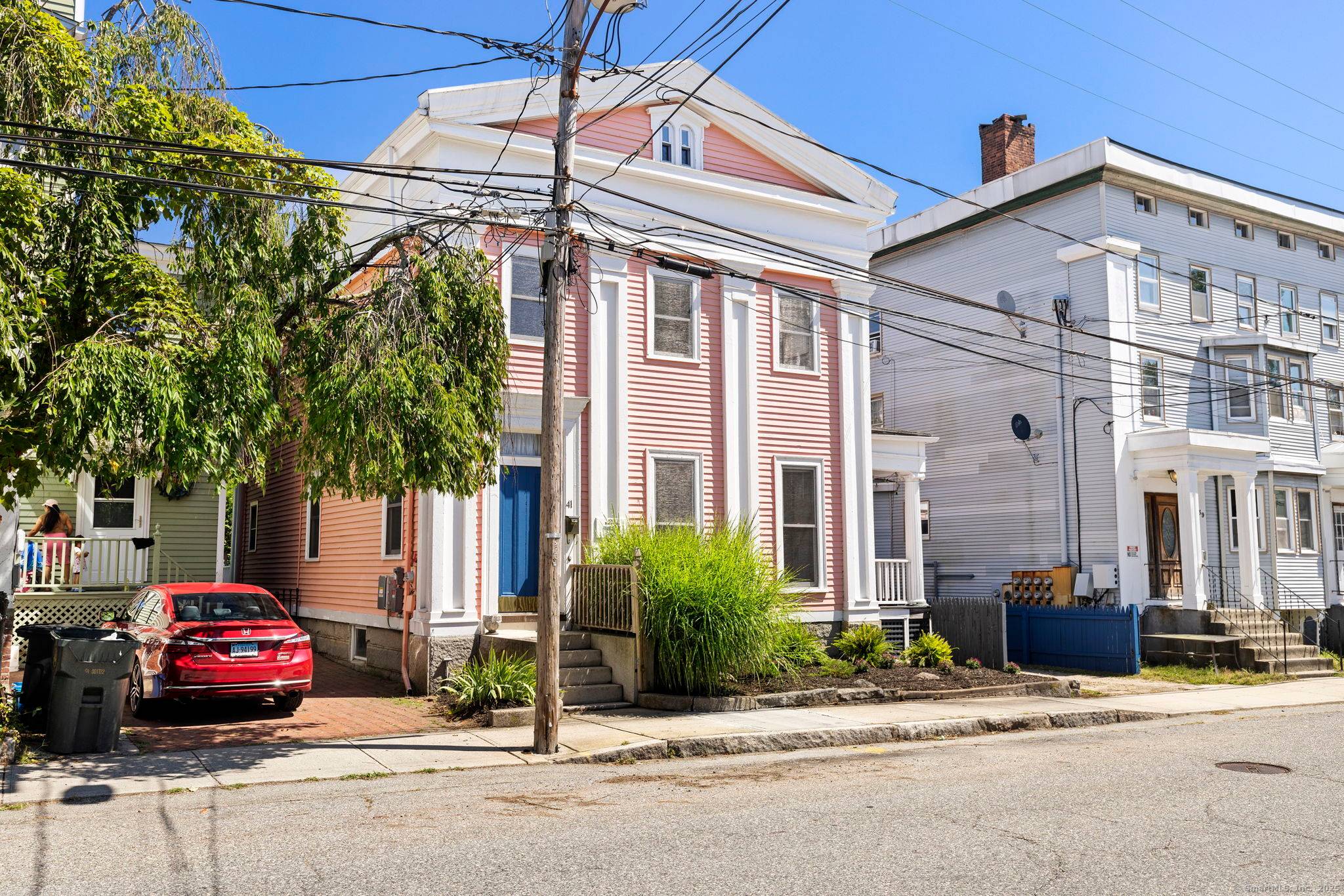 Welcome to 41 Tilley St a stately, artist loved Colonial with an eye catching pink exterior welcoming blue door in New London's Historic District.