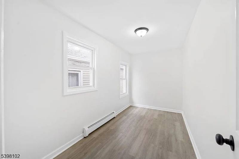 This vacant and renovated 2 family home in Elizabeth features updated interiors and new windows throughout.