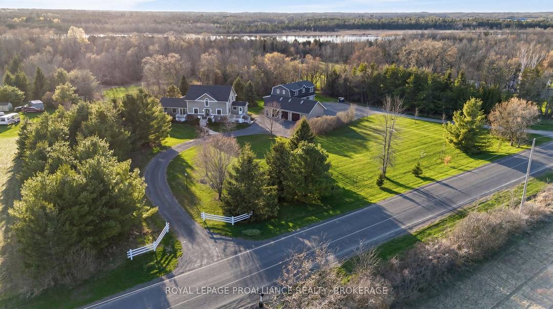 A winding laneway, lined with mature red maples to the right and northern pines to the left, draws you into 2489 Quabbin Road through a classic white fenced entrance.
