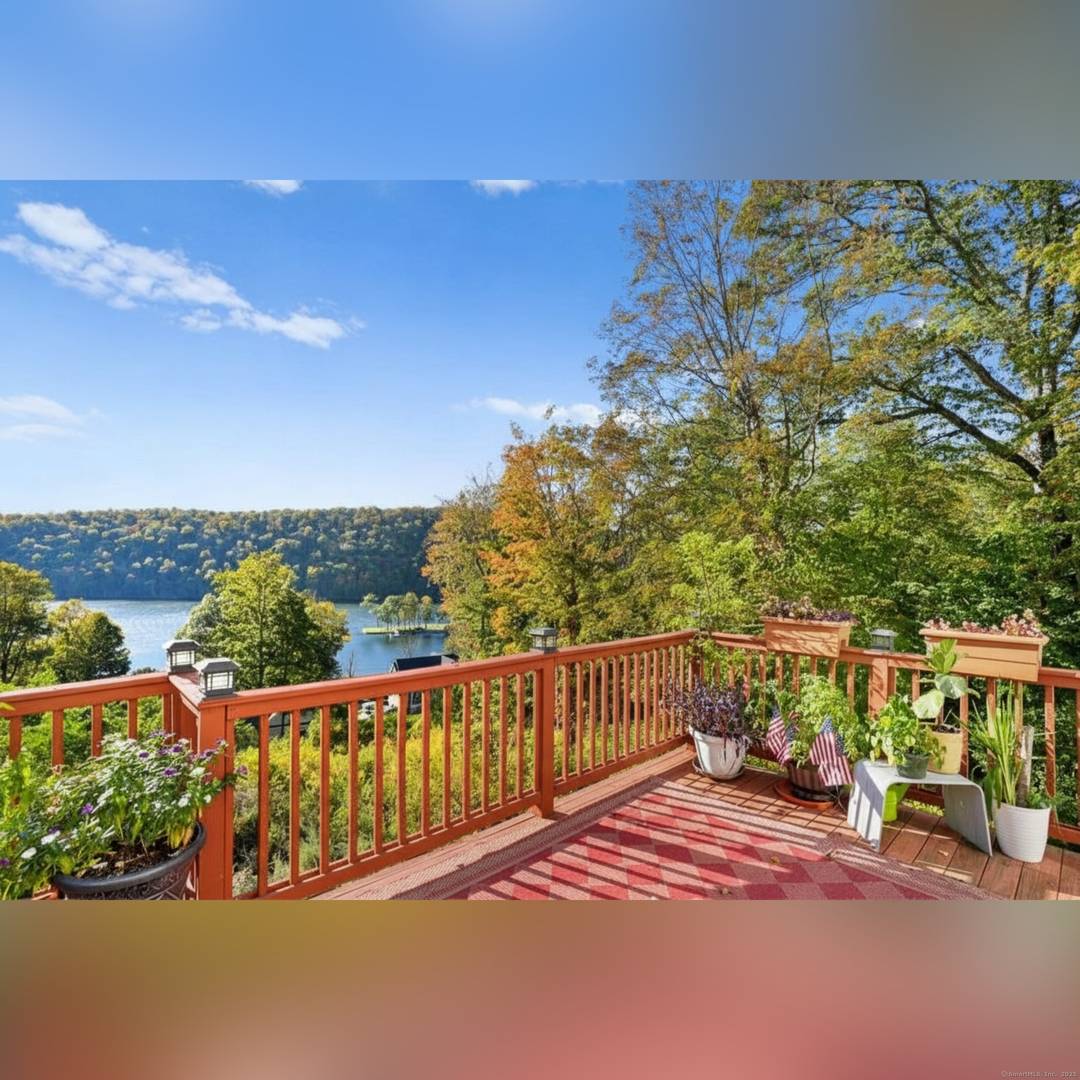 Experience classic New England charm in this beautiful colonial nestled at the bottom of a hill, offering gorgeous lake views from nearly every room.