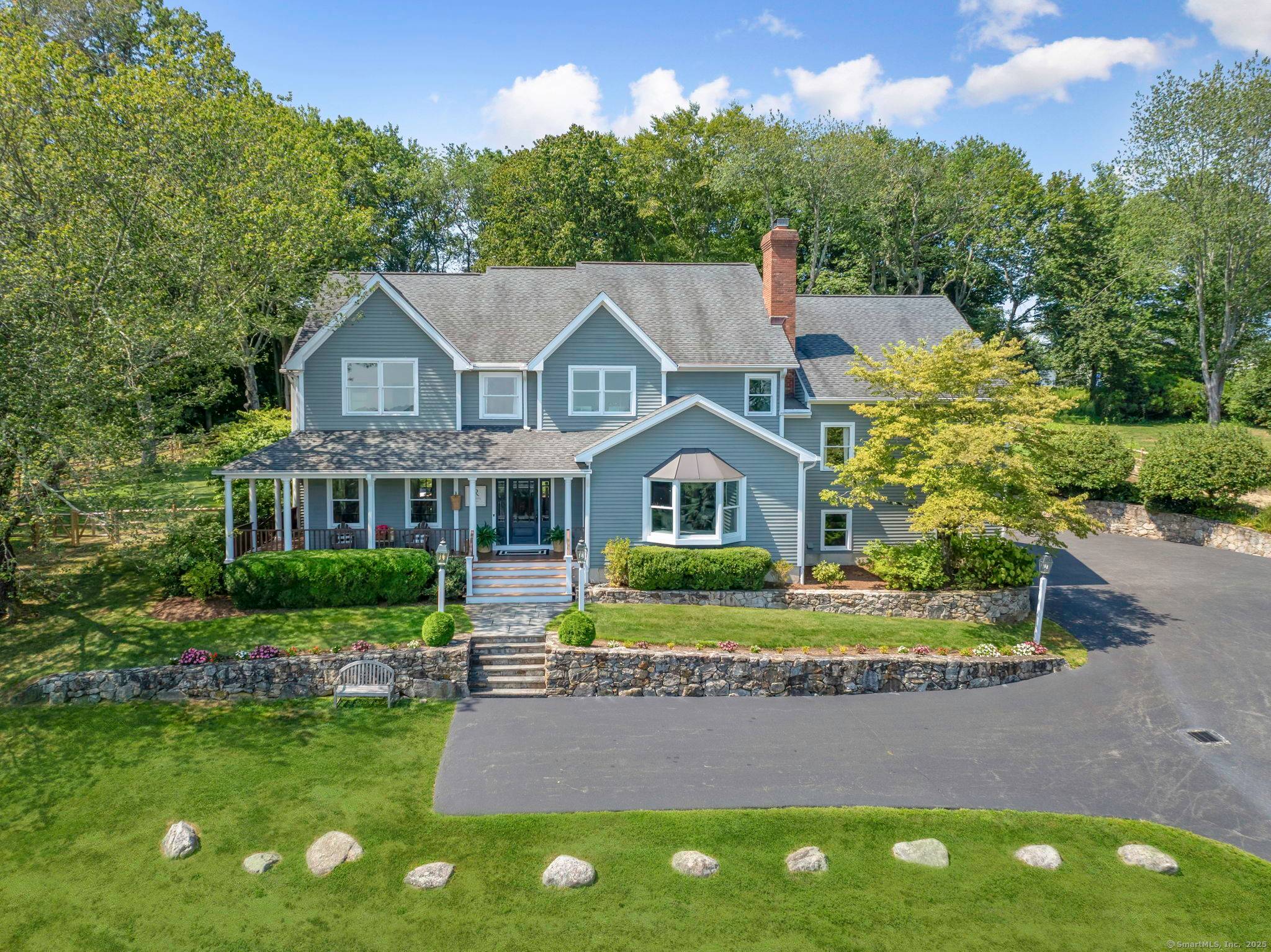 Set high atop a ridge in one of Wilton's most desirable neighborhoods, offering STUNNING views of expansive landscape from nearly every room as well as its wraparound porch, this magnificent, ...