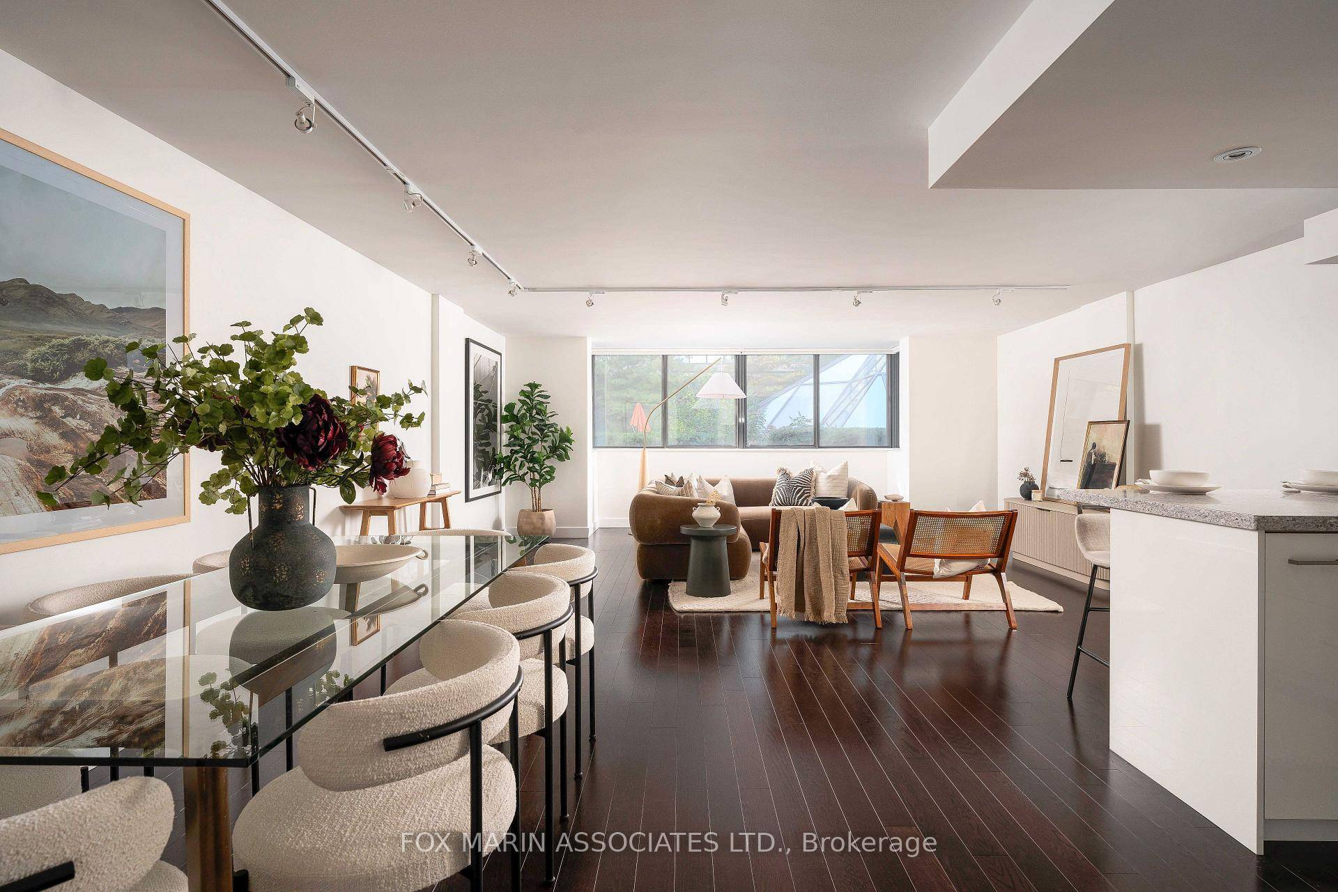 An oversized two storey residence that feels more brownstone than condo, a home collected, not constructed, with a splash of that Market Square buzz.